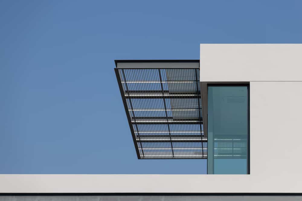 steel awning of modern house. exterior metal louver shading against blue sky.